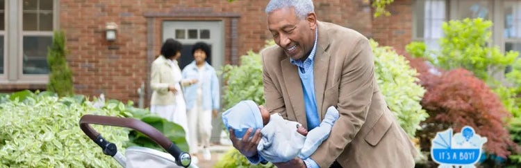 Image of a grandfather placing a baby in a carriage, as a grandmother and mother talk in the background (not real patients)