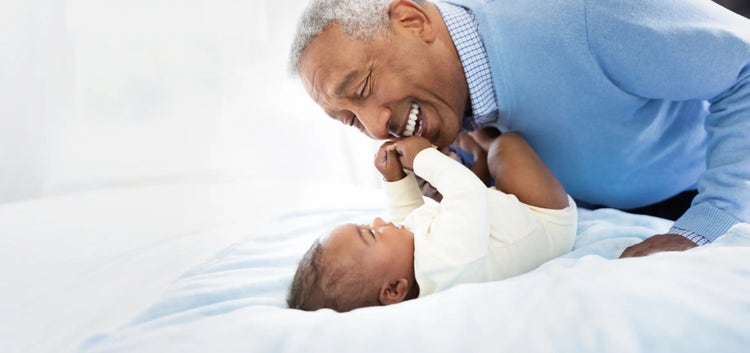 Image of grandfather playing with a baby (not real patients)