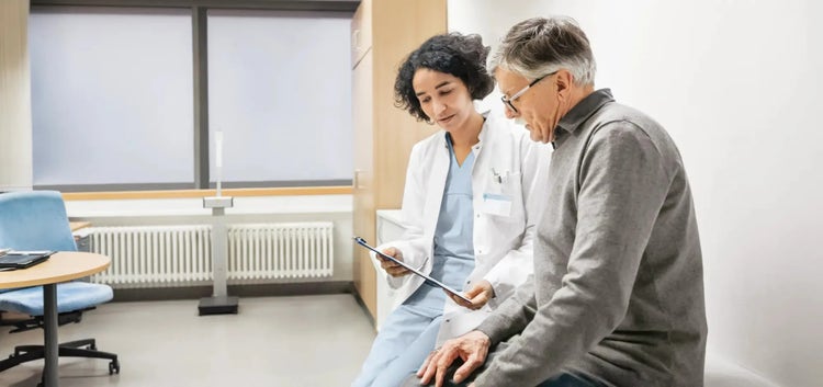 Image of a healthcare provider speaking to an older man (not real patients)
