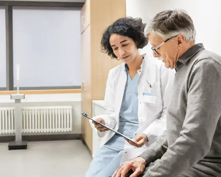 Image of a healthcare provider speaking to an older man (not real patients) mobile